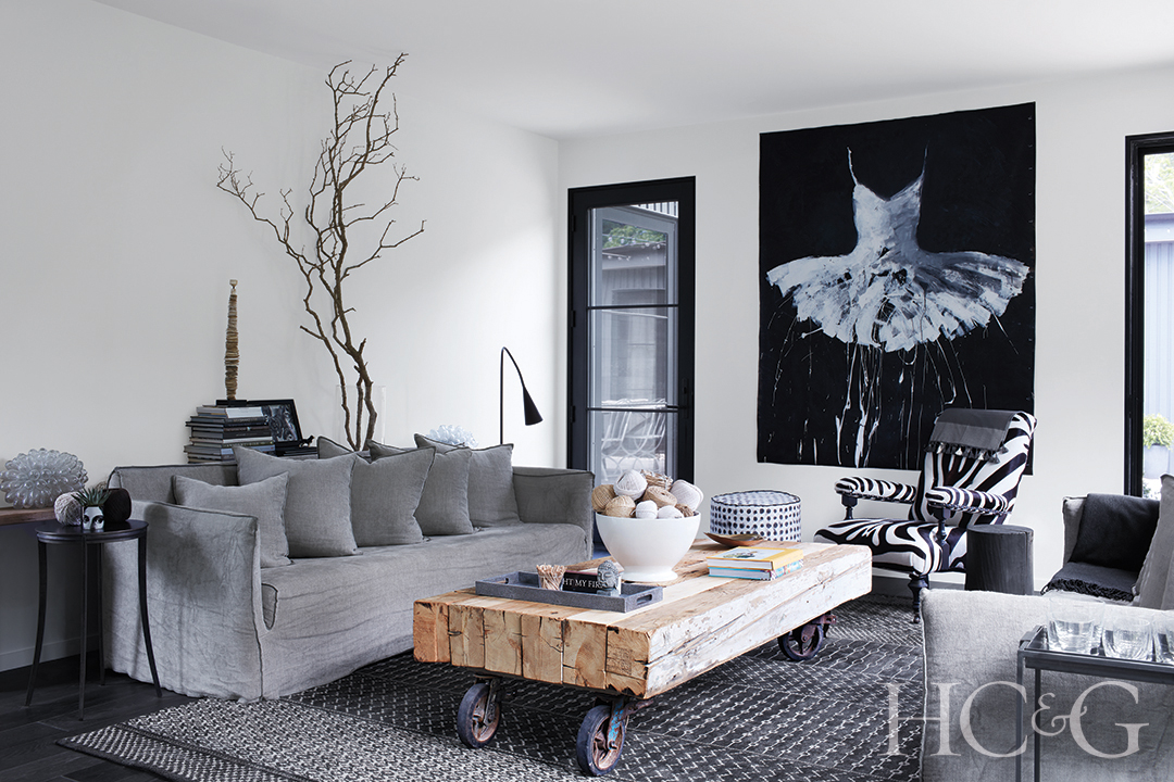 Italian linen sofa and custom cocktail table; zebra-print armchair in living room