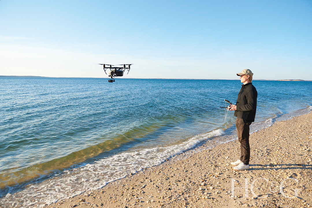 Man Flying Drone Over Ocean