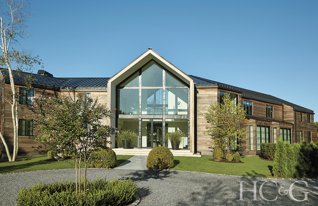 home exterior and landscape design; glass wall over entry