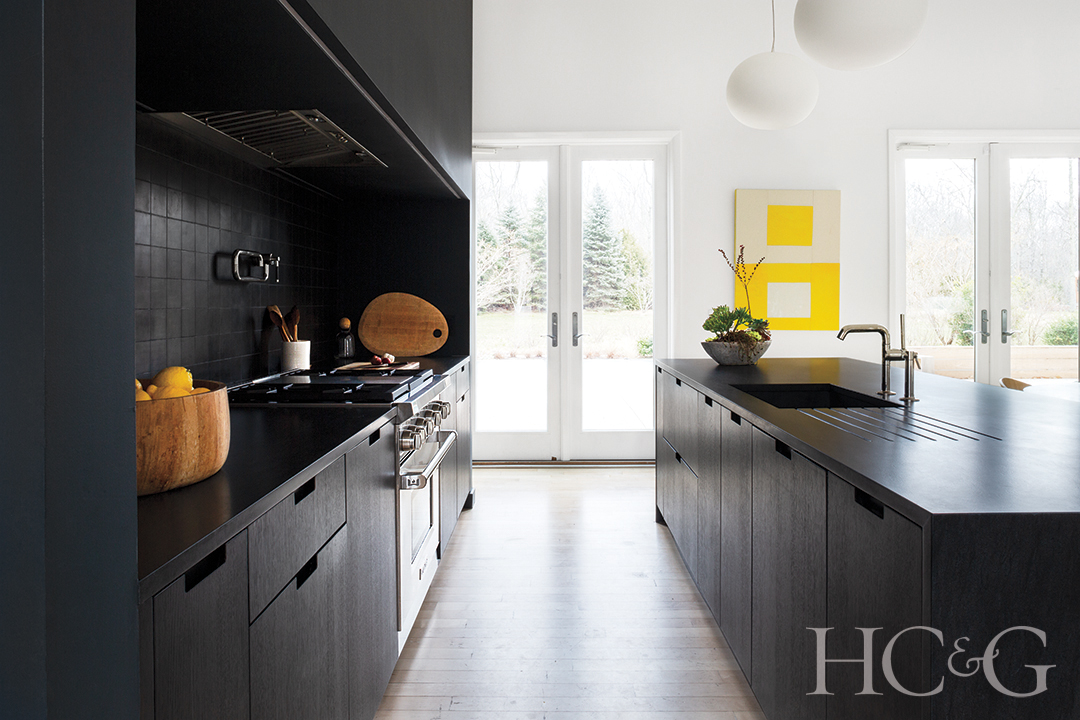 cabinetry and soapstone counters; stove, hood, sink, and pot filler