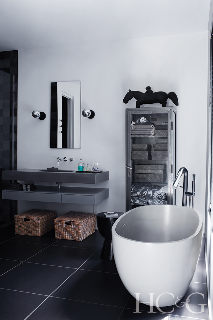 main bath features tub and black tile