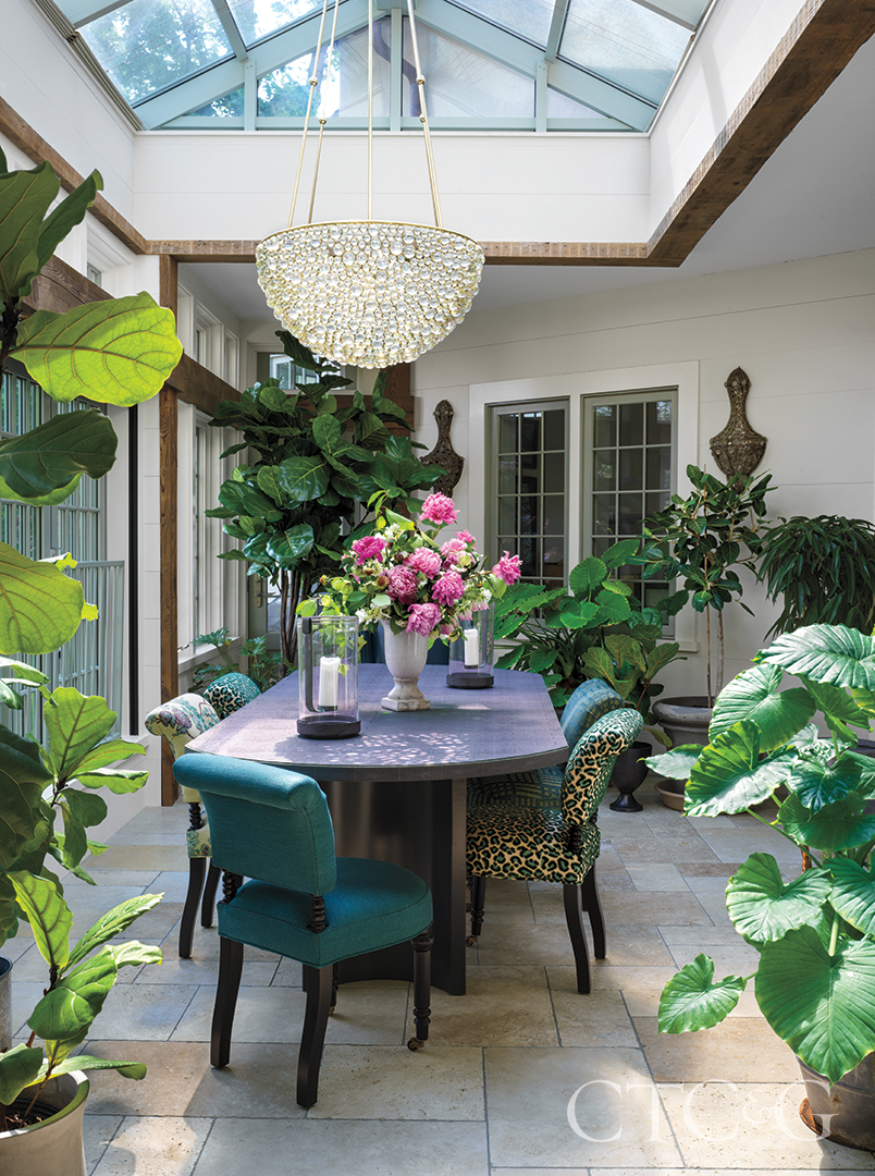 chandelier above dining table and floral arrangement in dining room