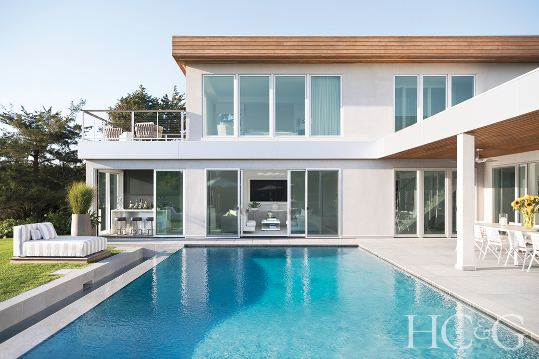 pool in rear of home; patio tables and chairs