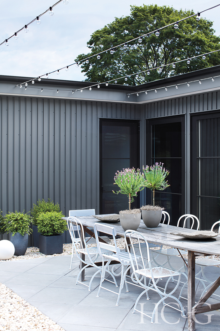 string lights hang over outdoor dining area