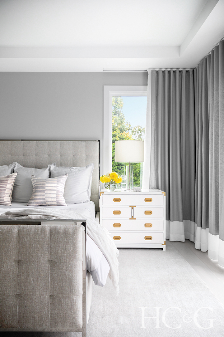 guest room bed and bedding; gray curtains and rug