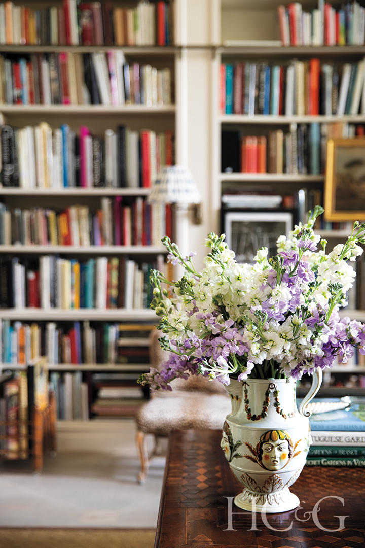 Library With Built In Shelves And Purple And White Flower Arrangement