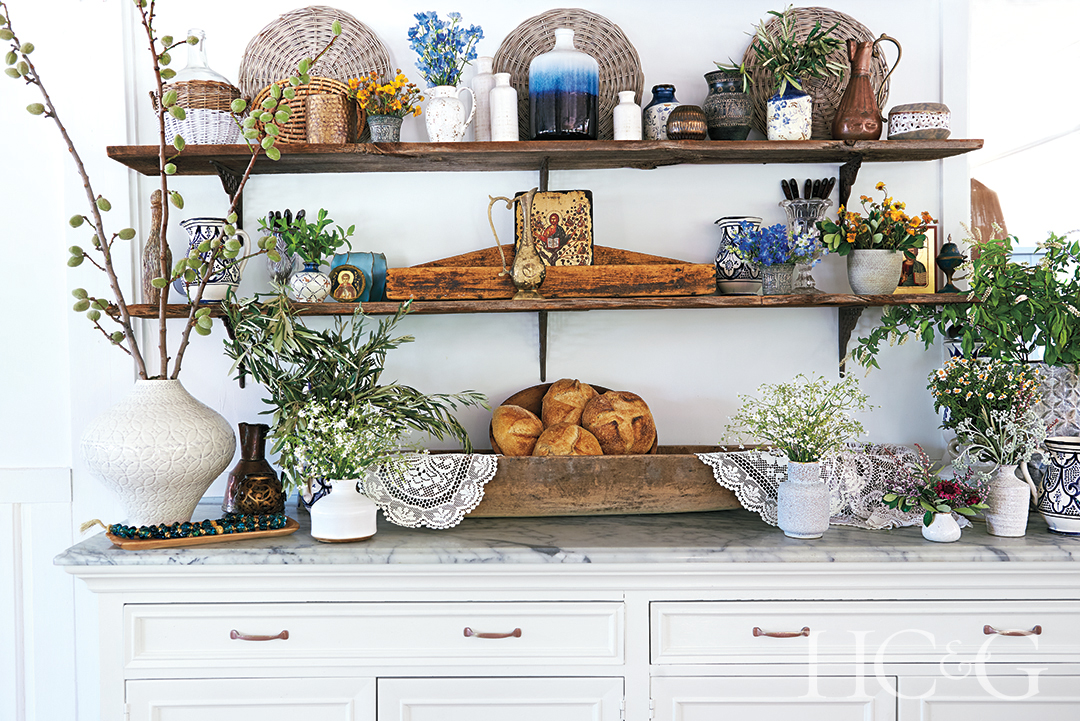 olive and almond branches and chamomile decorate a credenza