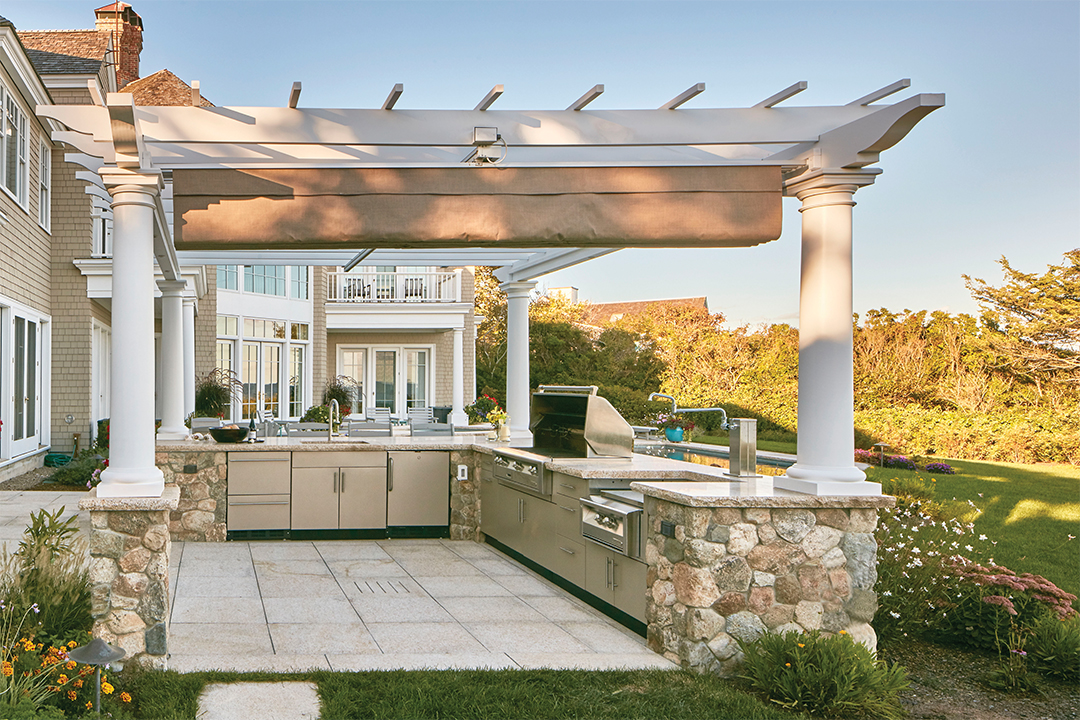 outdoor kitchen with pergola and stone