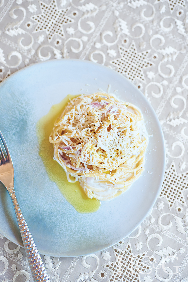 pasta dish made with caramelized red onions, Greek yogurt, lemon zest, and a drizzle of Kosterina olive oil
