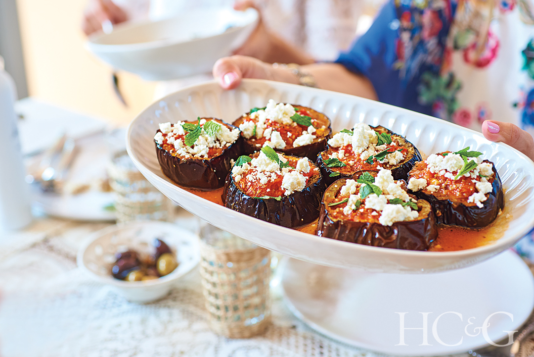 baked eggplant with onions, garlic tomato sauce, and feta garnished with mint