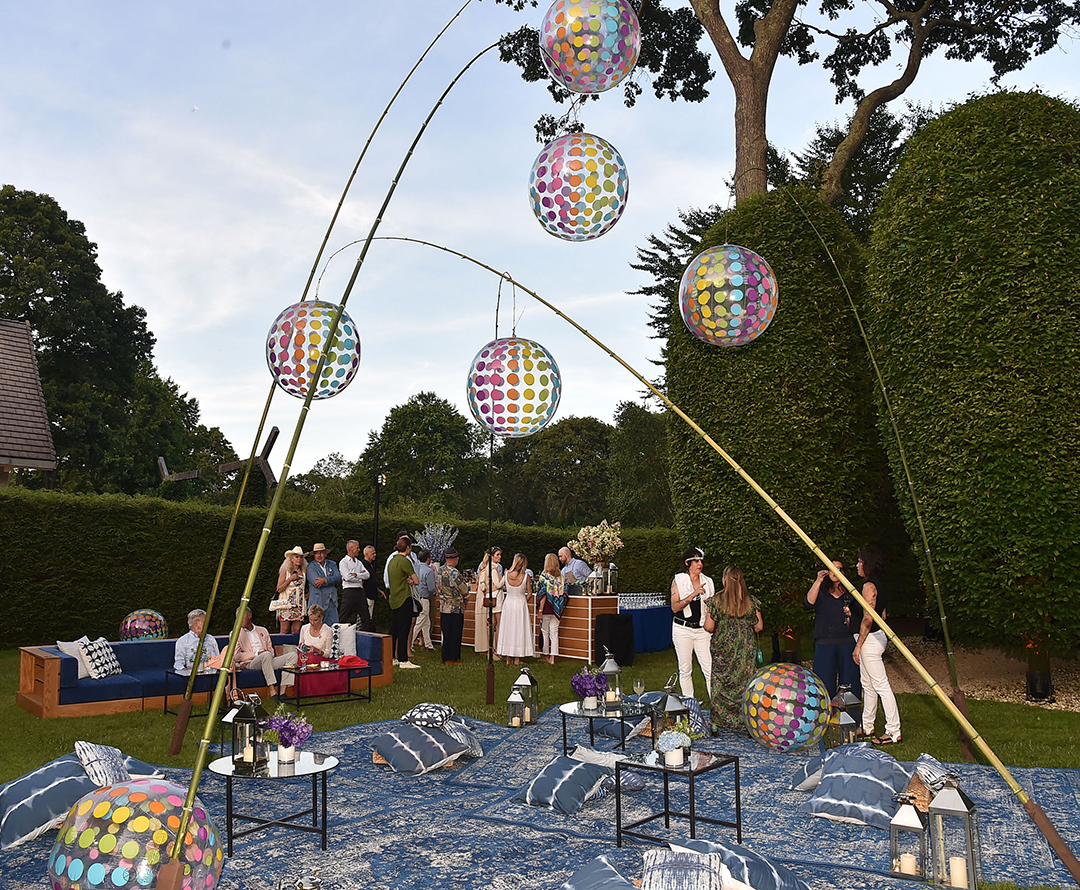 large ball sculptures showing people mingling