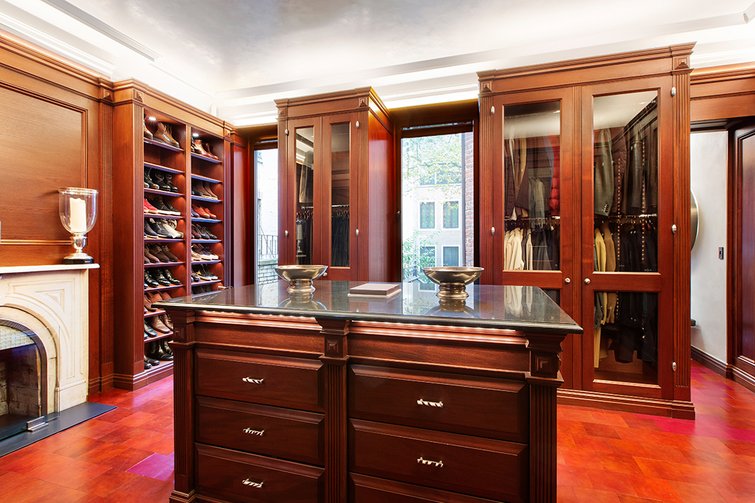 traditional dark wood cabinets in walk-in closet