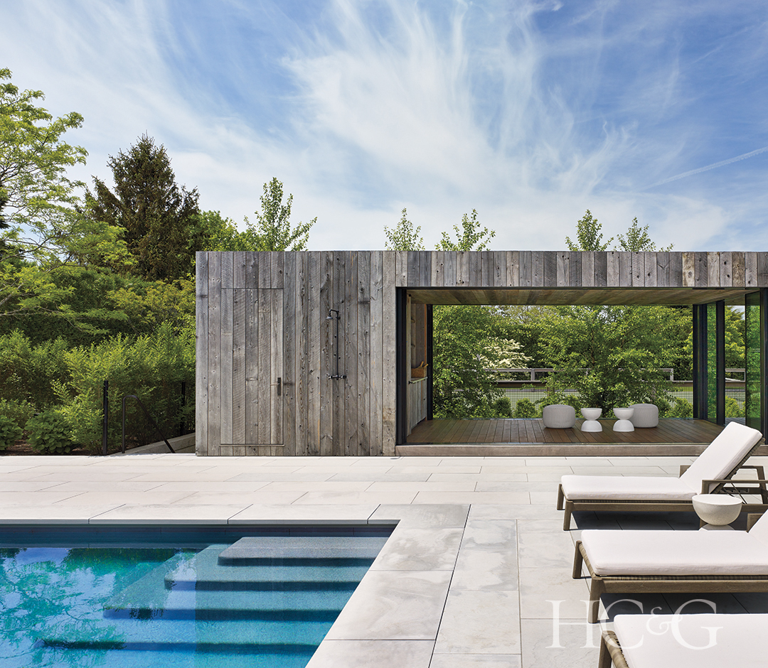 slatted modern pool house, chaise lounges, pool