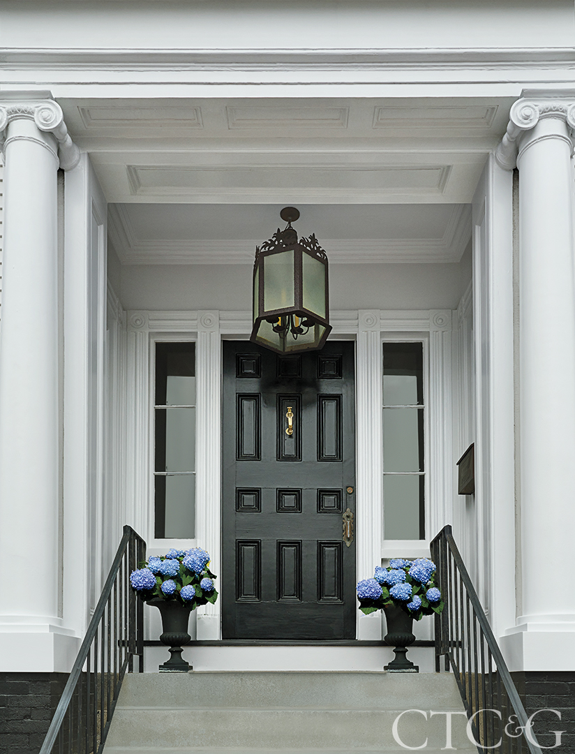 black front door with blue hydrangeas