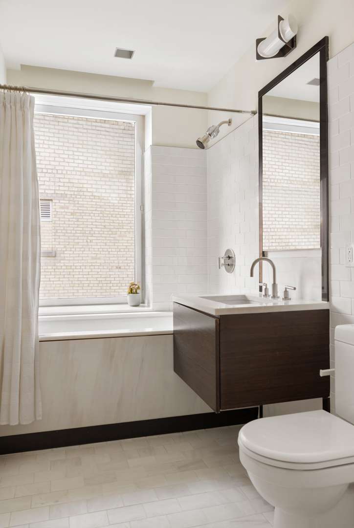 A clean, tiled Manhattan bathroom