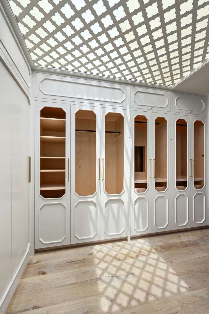 White closet space with patterned ceiling