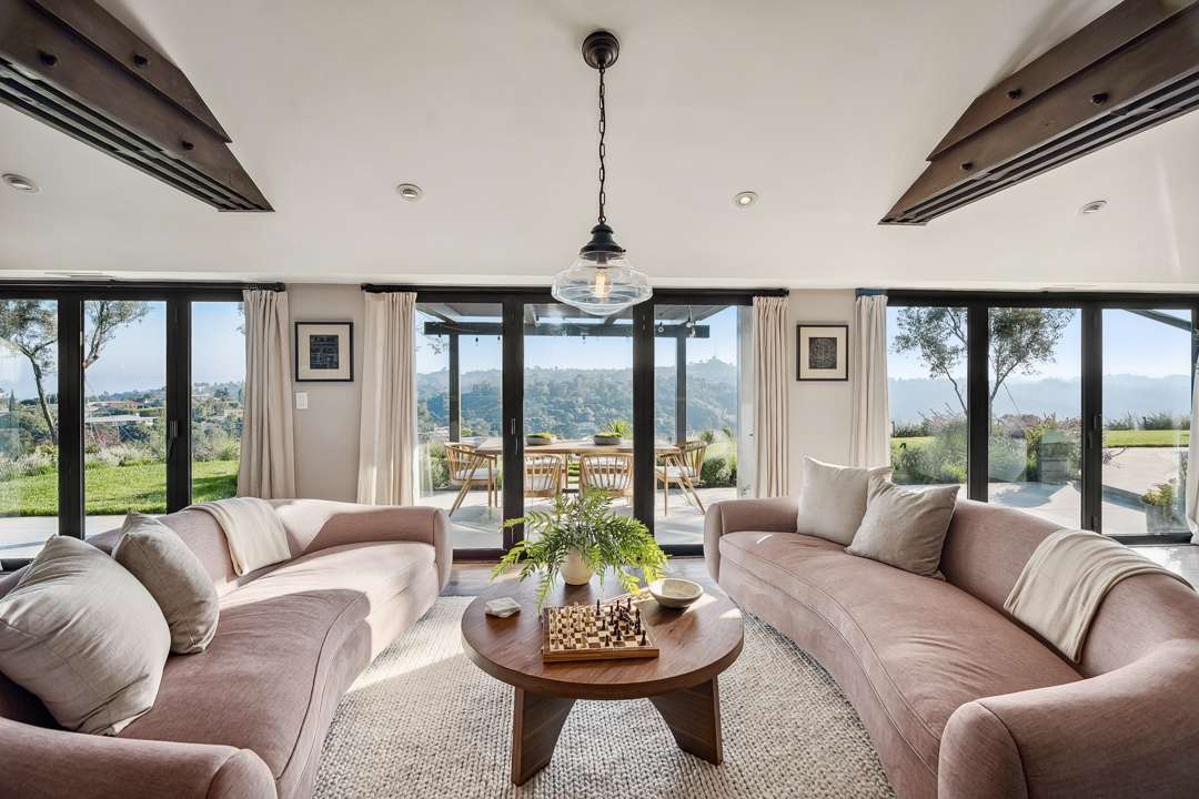 Two roundly shaped couches furnish comfortable seating area