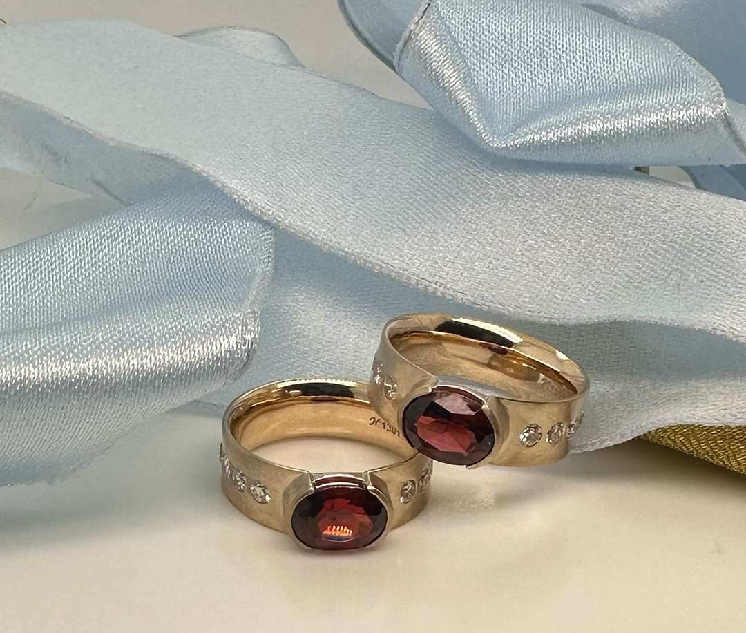 Gold earrings with red jewel