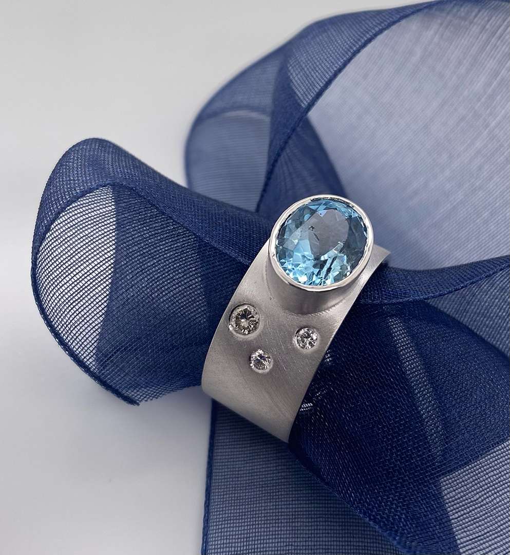 Silver ring with blue jewel