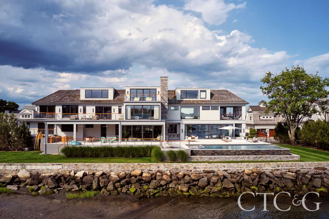 Spacious backyard with minimal plantings and ornamental grasses for texture