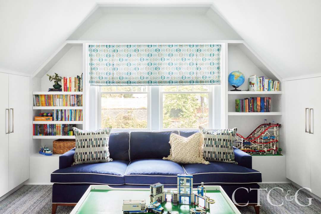 Blue couch sits in sunlit playroom