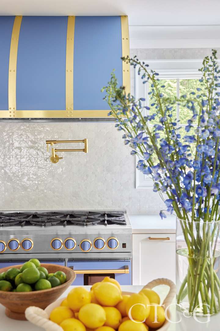 Pigeon Blue stove and hood decorate riverside kitchen