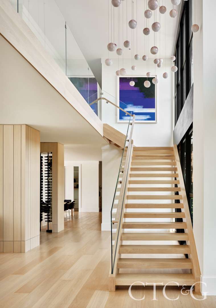 Clean, wooden entryway with custom chandelier