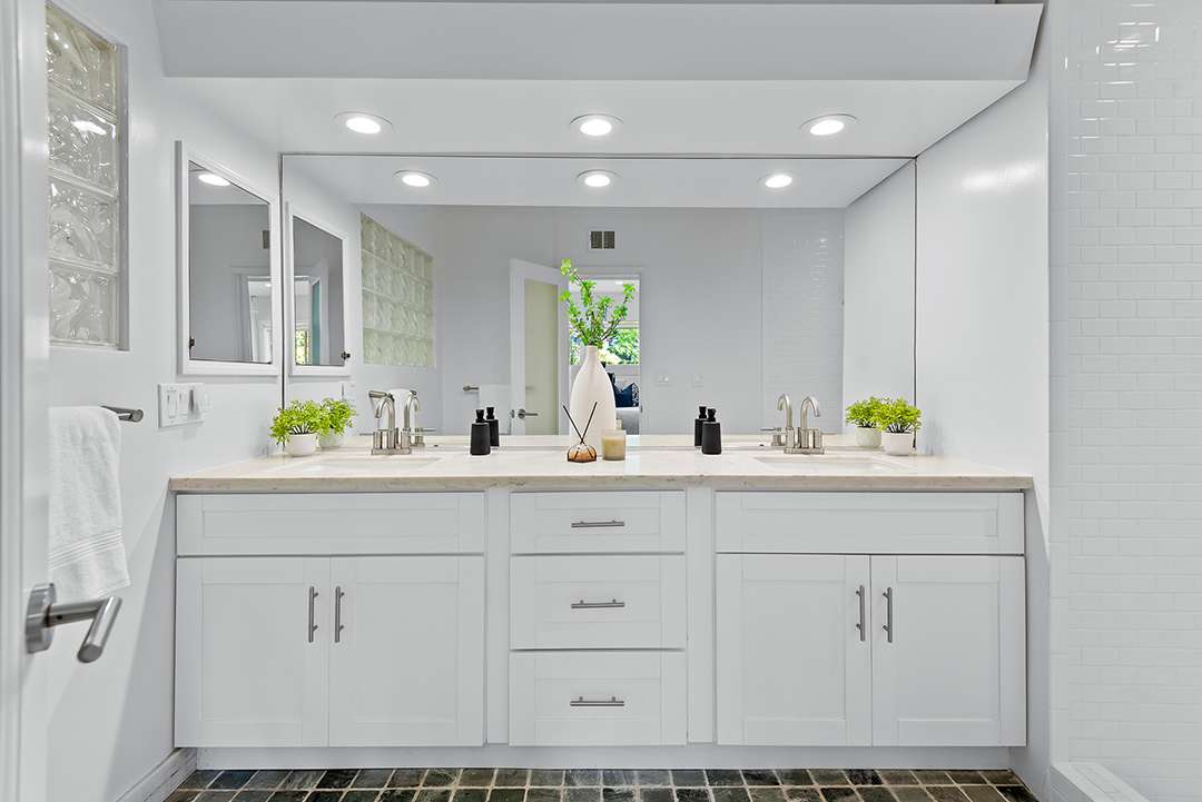 Spotless bathroom with white cabinetry.