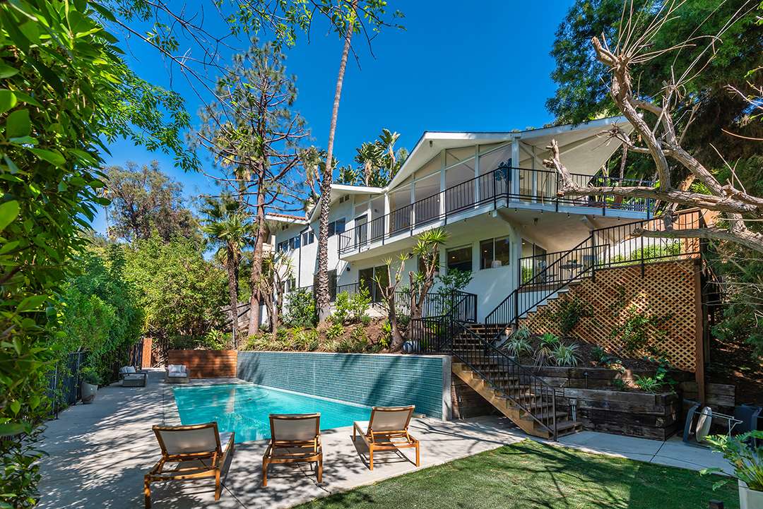 Impressive staircase leads from outdoor balcony to pool