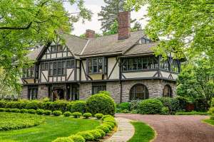 Ogranized landscape outside of tudor revival manor