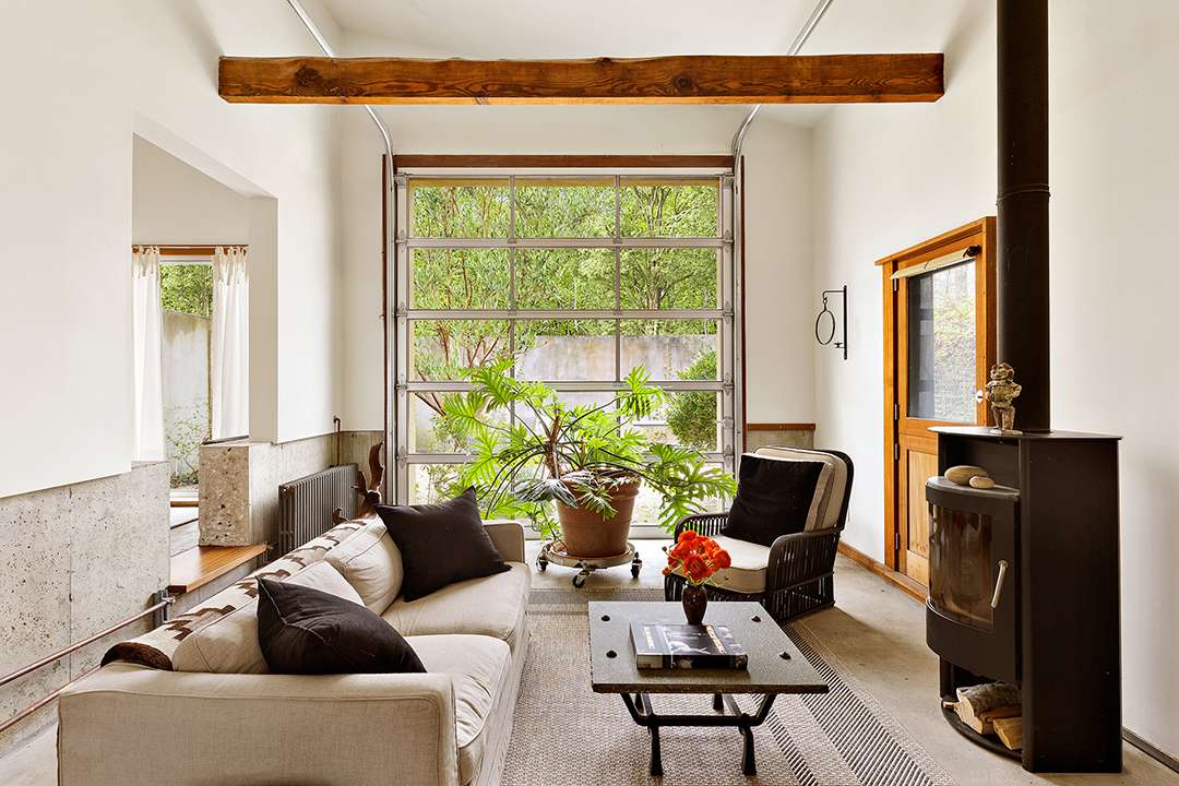 Modern garage door lets light into seating area