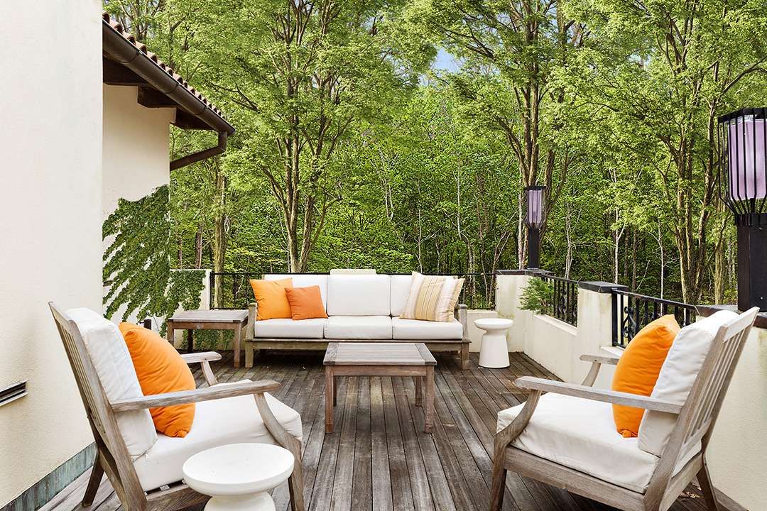 Orange pillows add color to outdoor living space