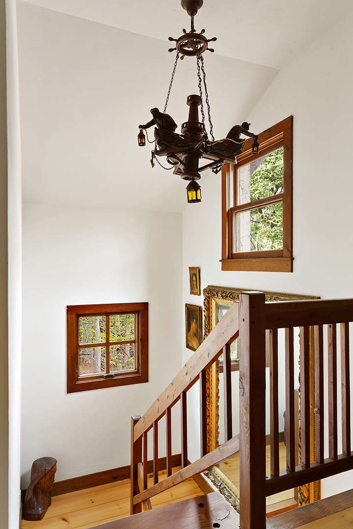 Unique chandelier hangs above staircase