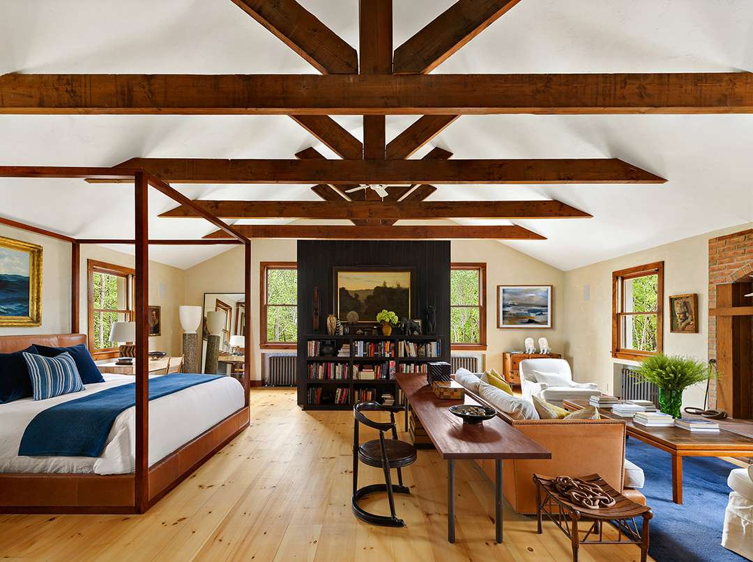 High-ceiling bedroom with black bookshelf