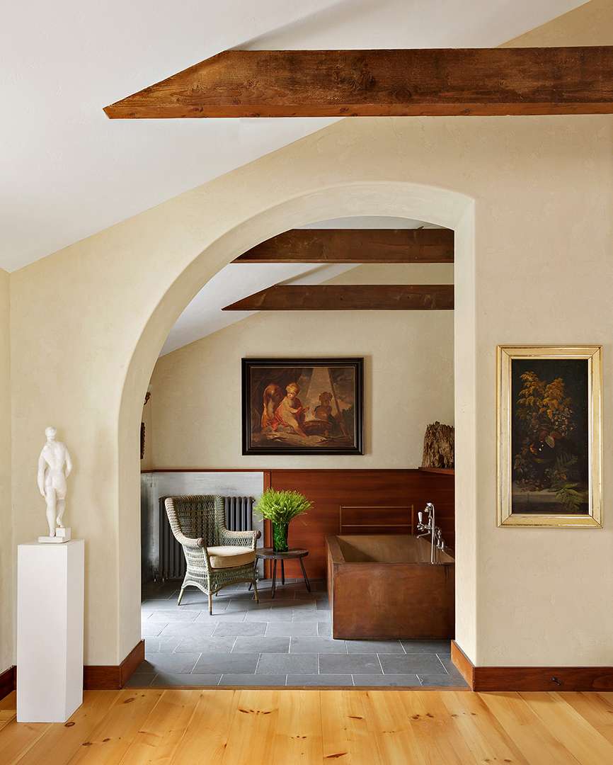 Round entryway to tiled bathroom