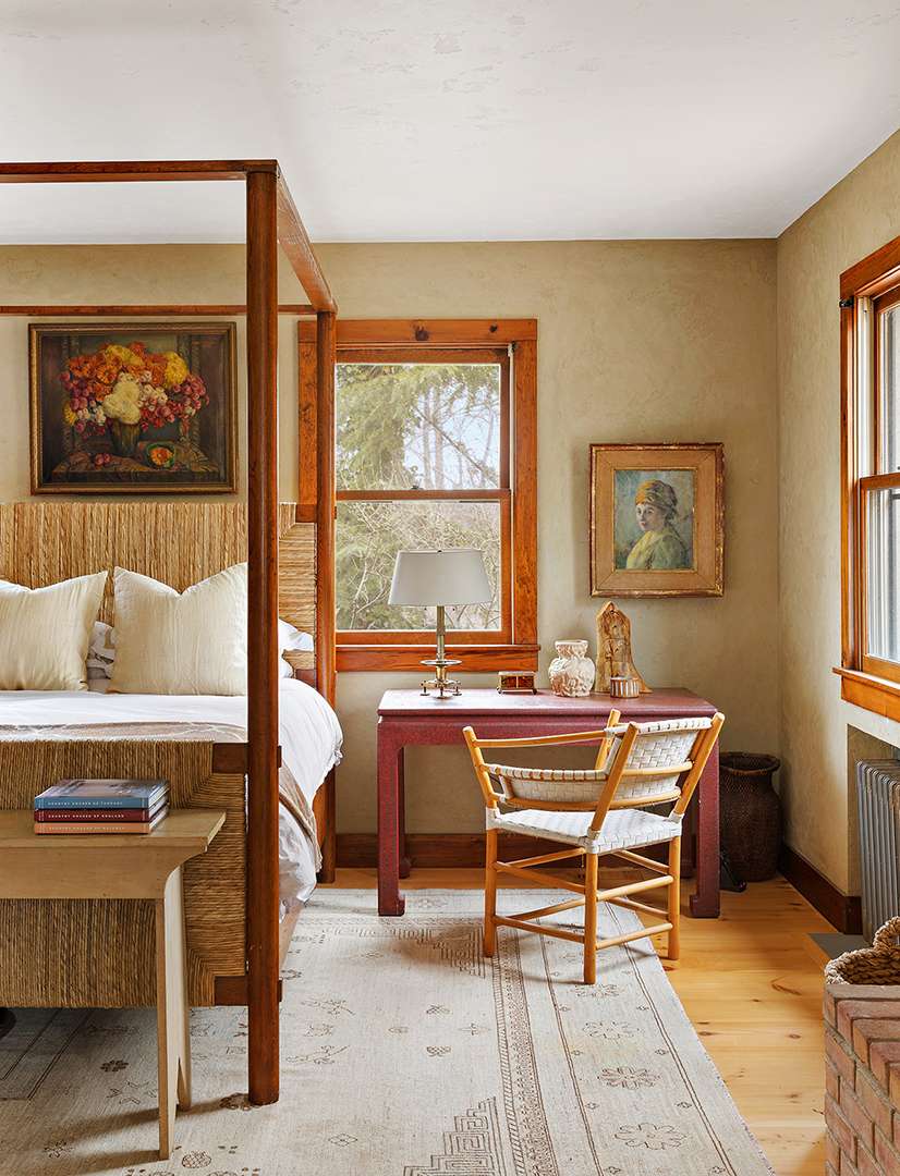 Traditional desk sits next to bed