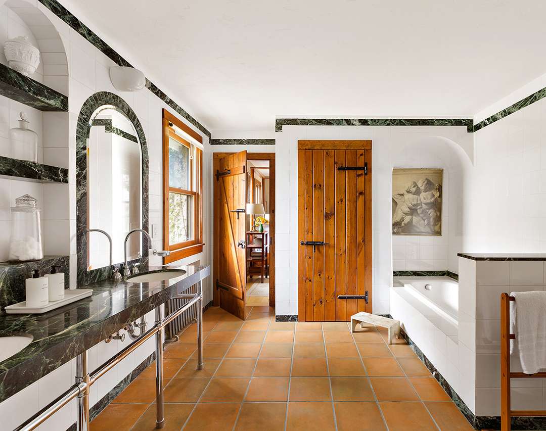 Unique bathroom with bathtub and tiled mirror