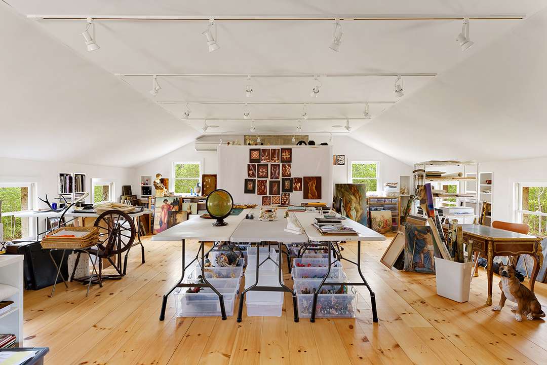 Spacious work area full of artwork