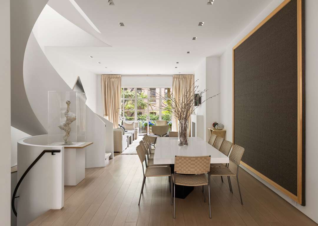 Neutral dining room next to stairs
