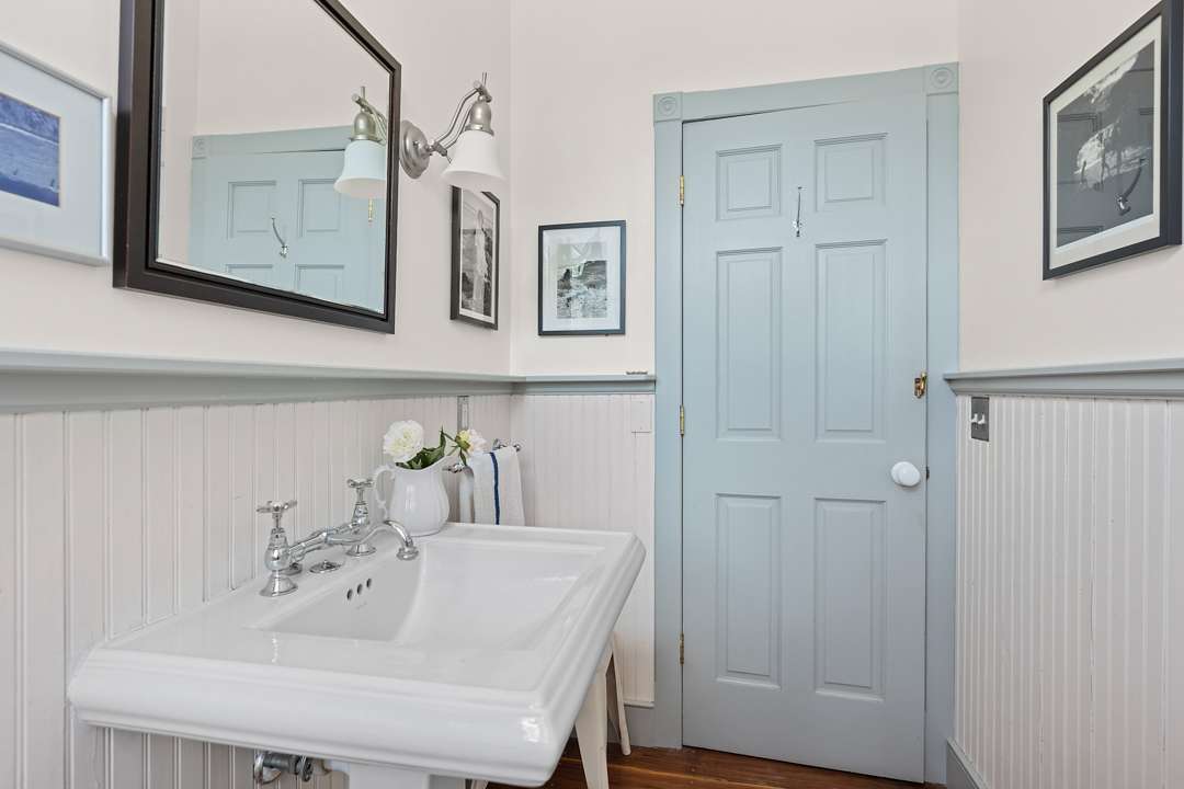 Bathroom with white sink and blue door