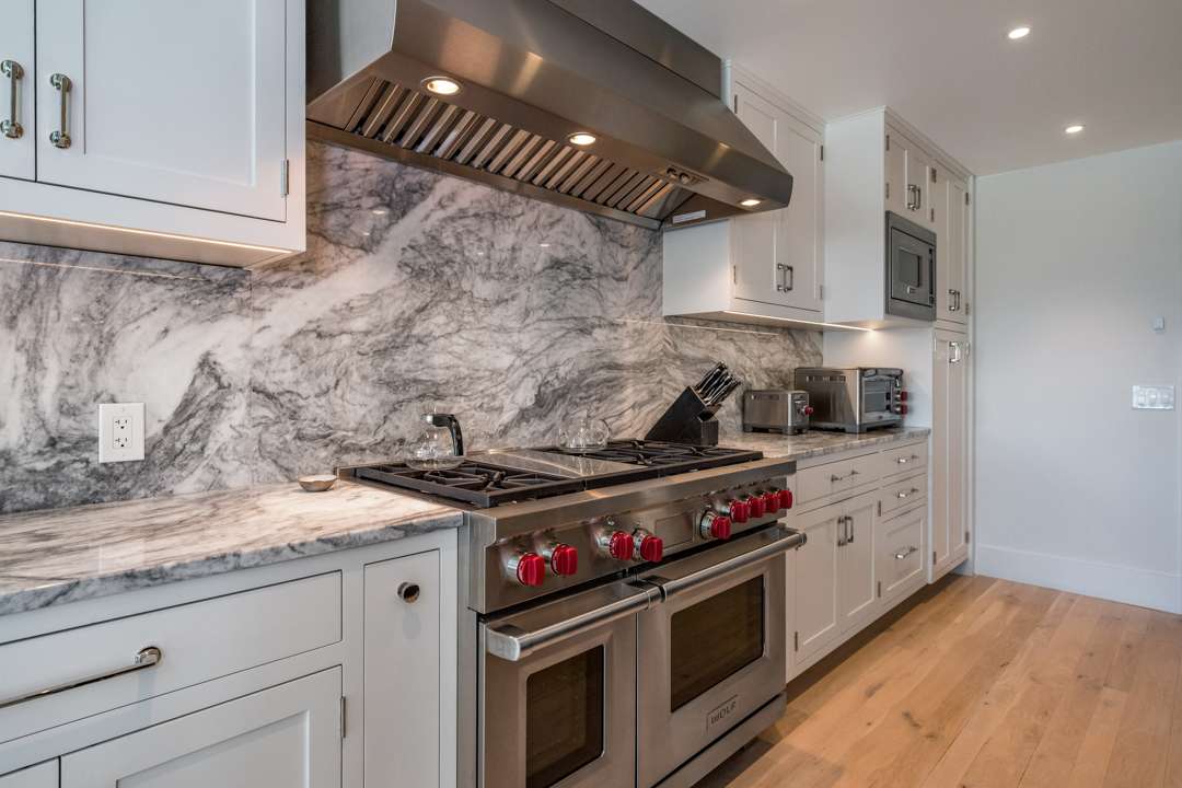 Kitchen stove with marble backsplash and counters