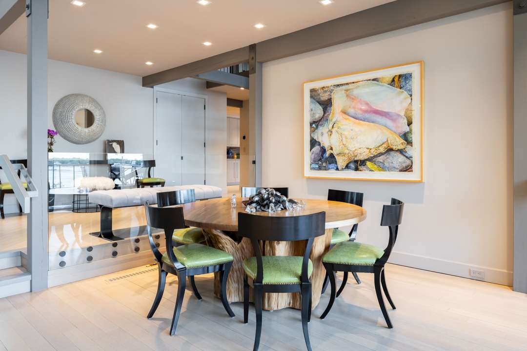 Wood dining table with green cushioned seats