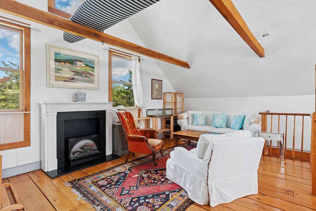 Living room with white furniture and red and blue accents