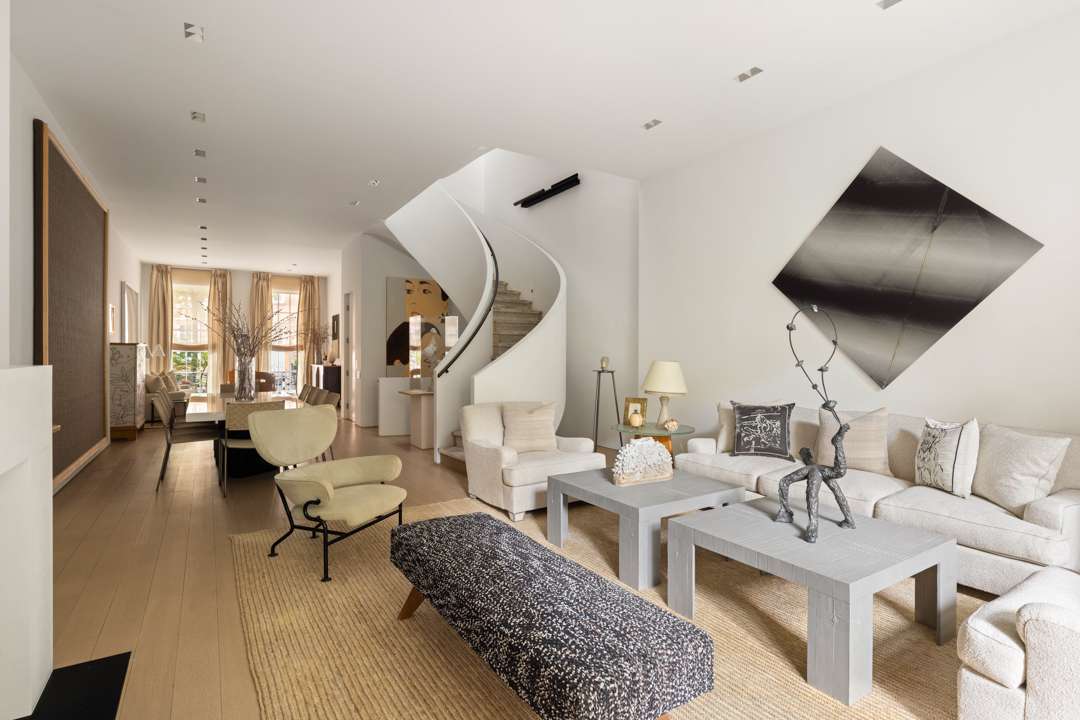 Neutral living room with fun art and staircase