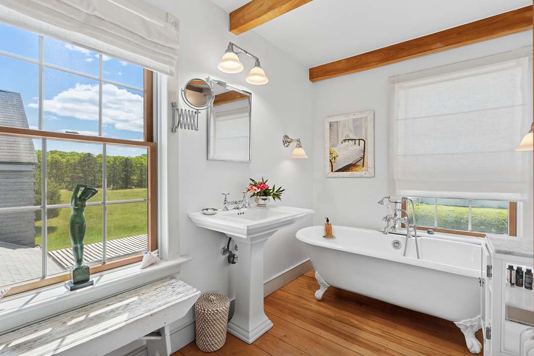 White bathroom with wood beams and floors
