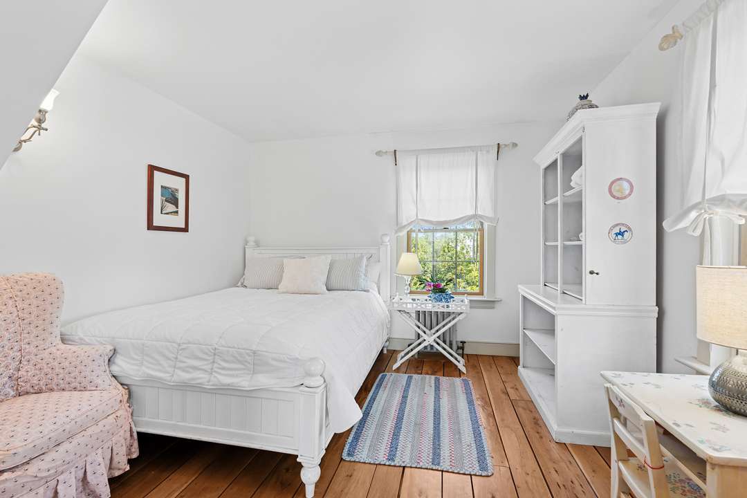 White bedroom with pink and blue accents