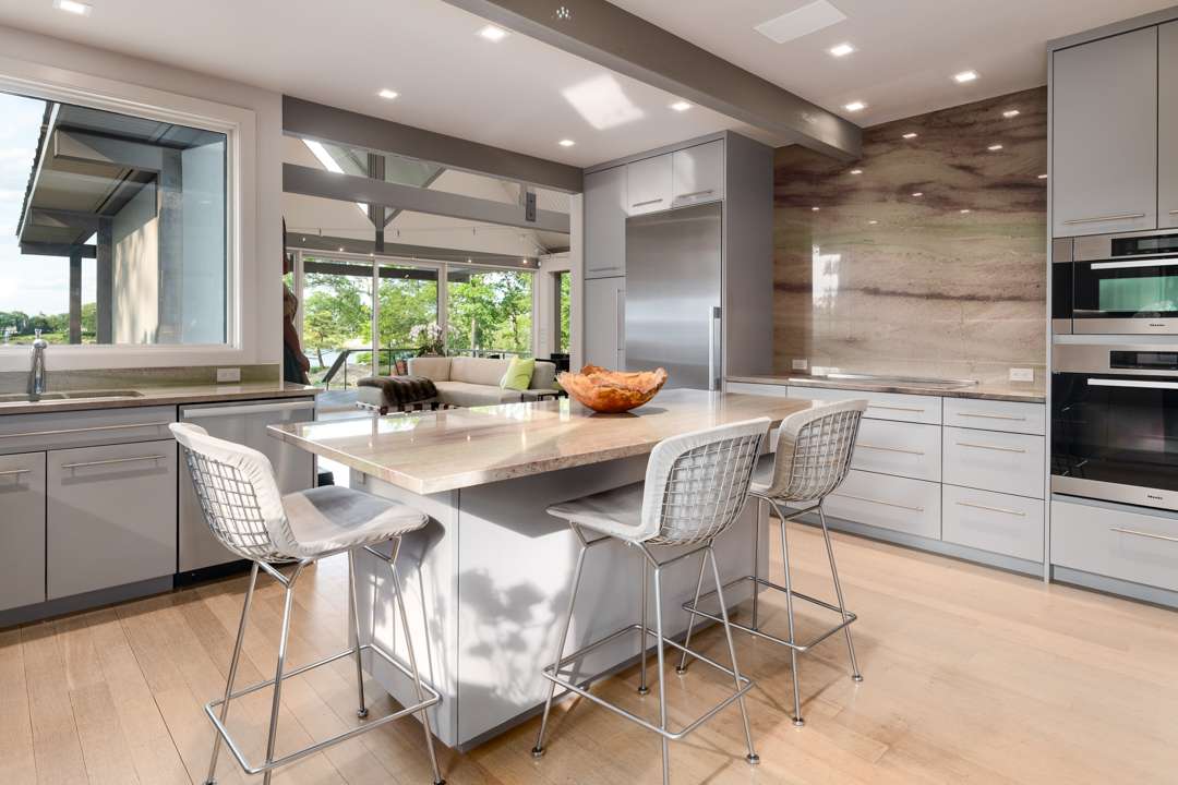 White and gray kitchen with marble counters and island