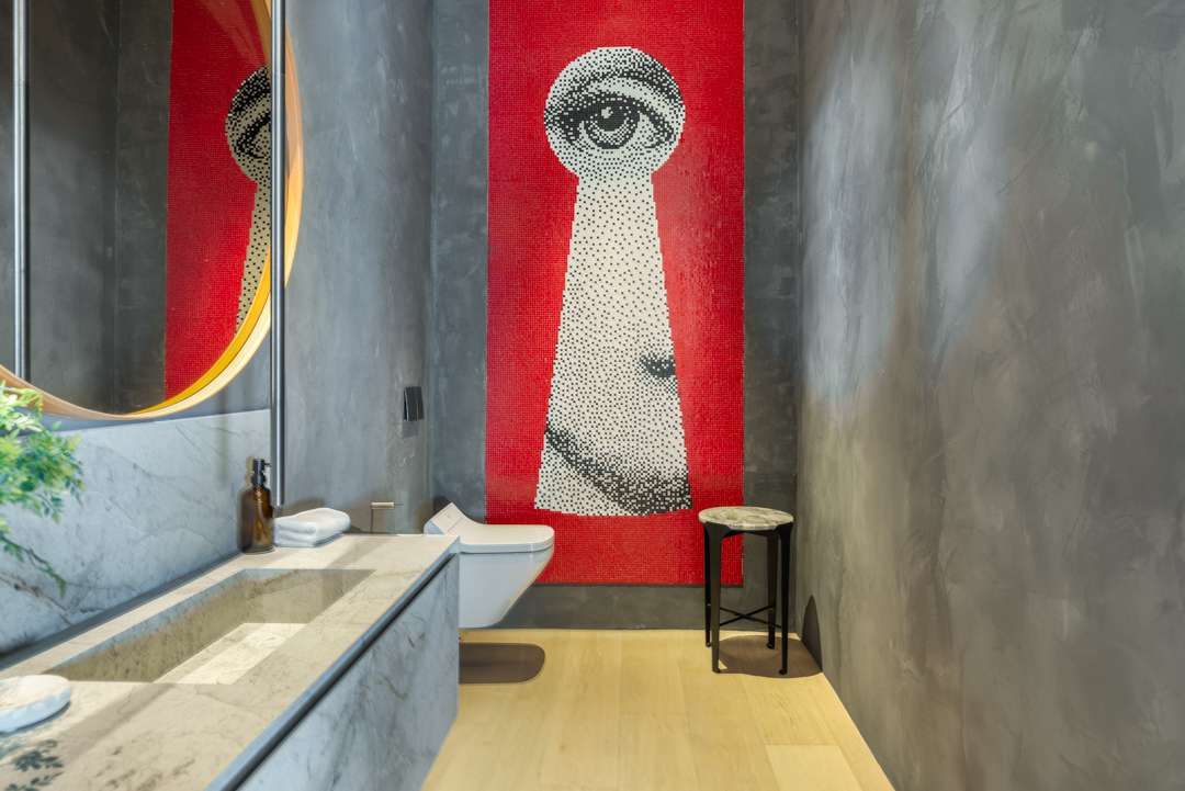 Bathroom with red, black, and white eye artwork