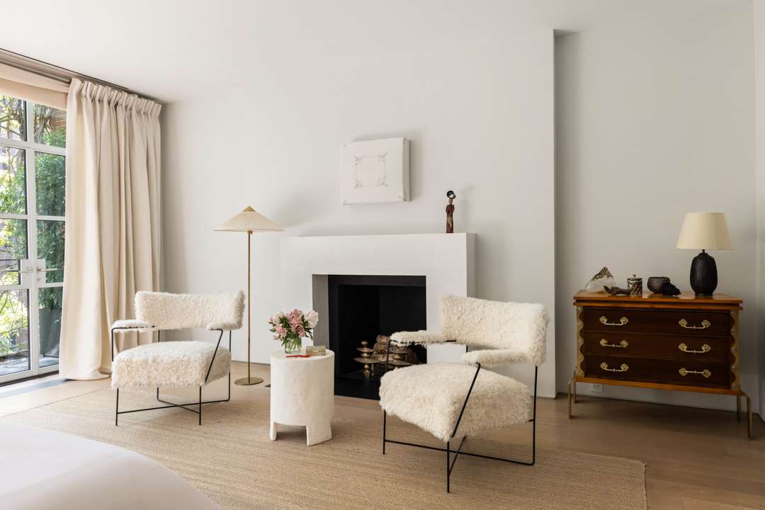 White bedroom with furry chairs
