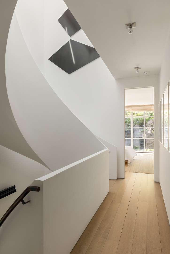 Hallway next to white spiral staircase